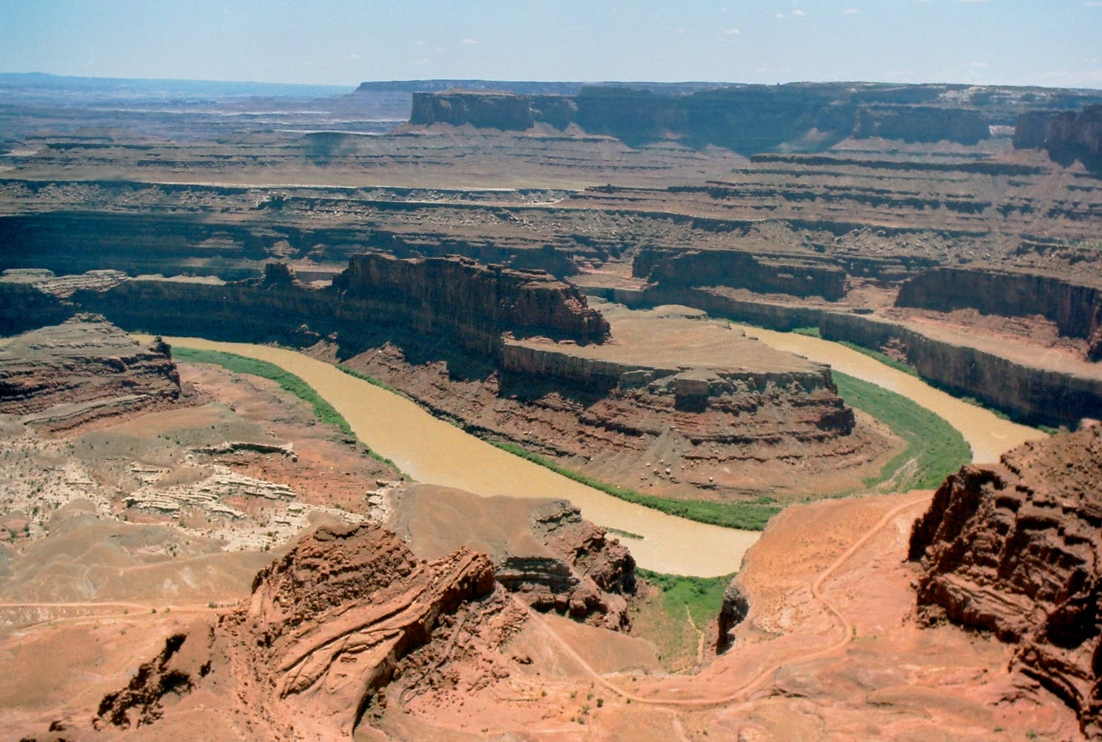 View from Dead Horse Point over a gooseneck bend of the Colorado River, canyon walls layered below the rim