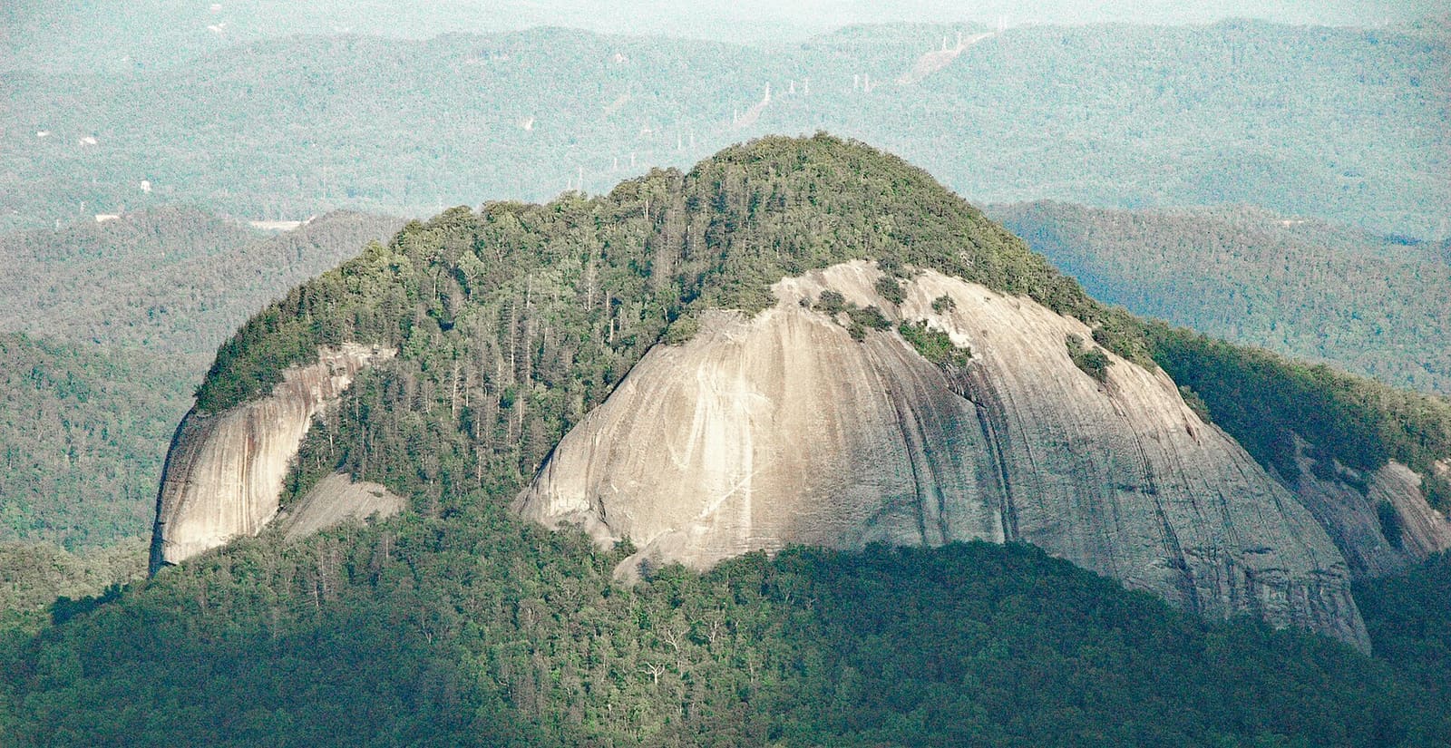 Looking Glass Rock, a large granite exfoliation dome rising above the forest in the Pisgah Ranger District